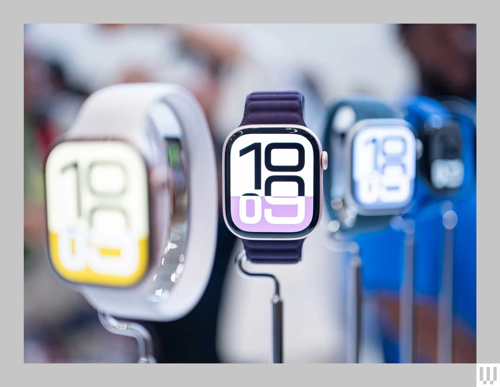 A row of smart watches on narrow stands