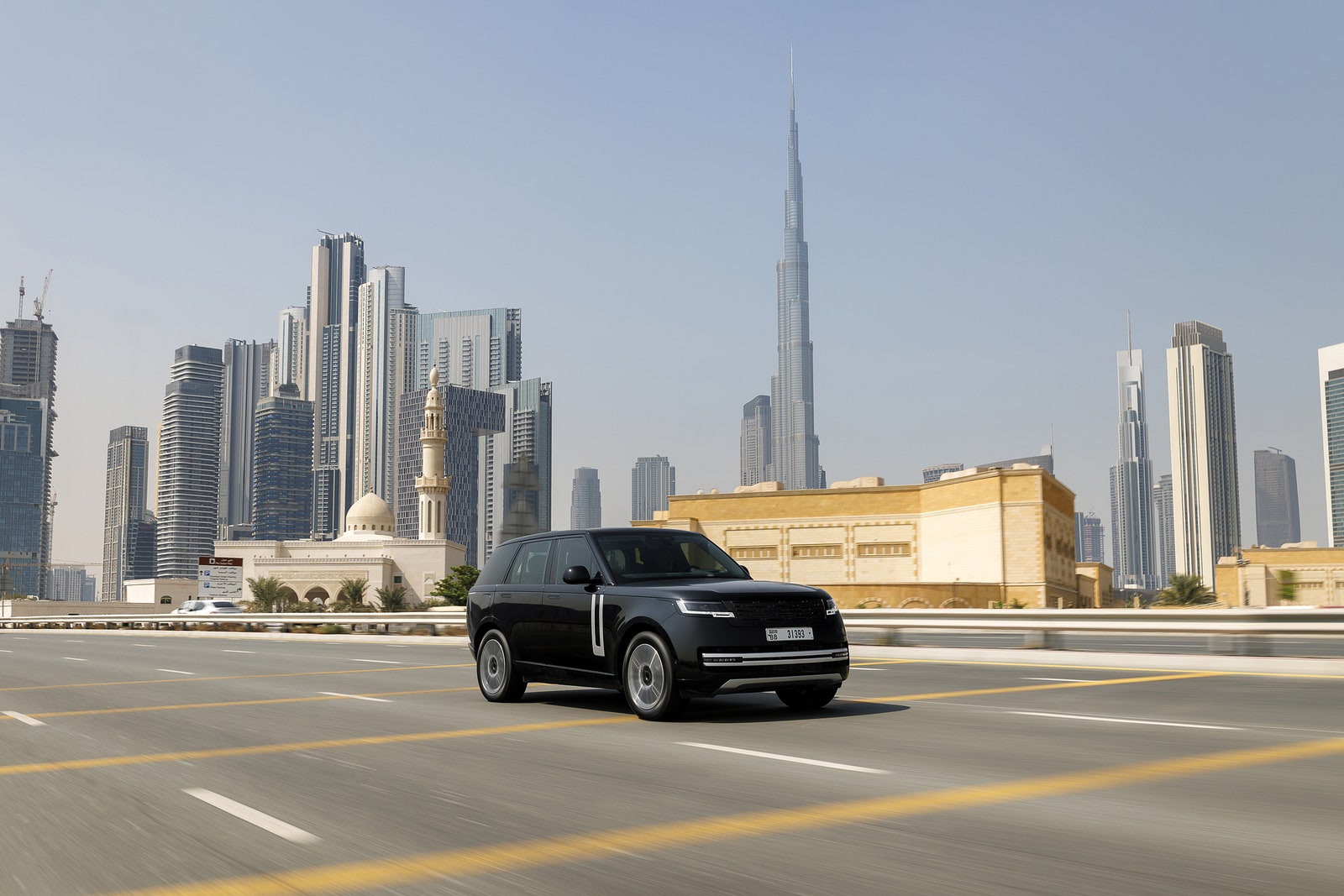 A black SUV with a city skyline behind