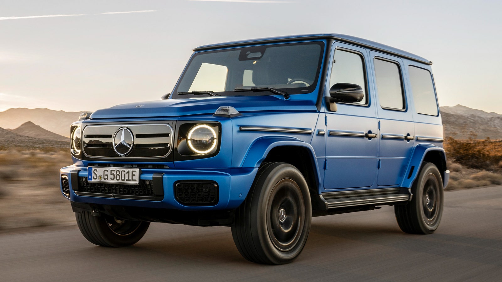 A boxy blue SUV on a rural road
