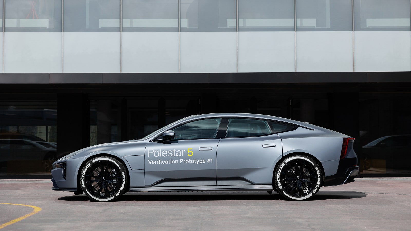 A sleek grey car that says Polestar 5 Verification Prototype 1 on the side