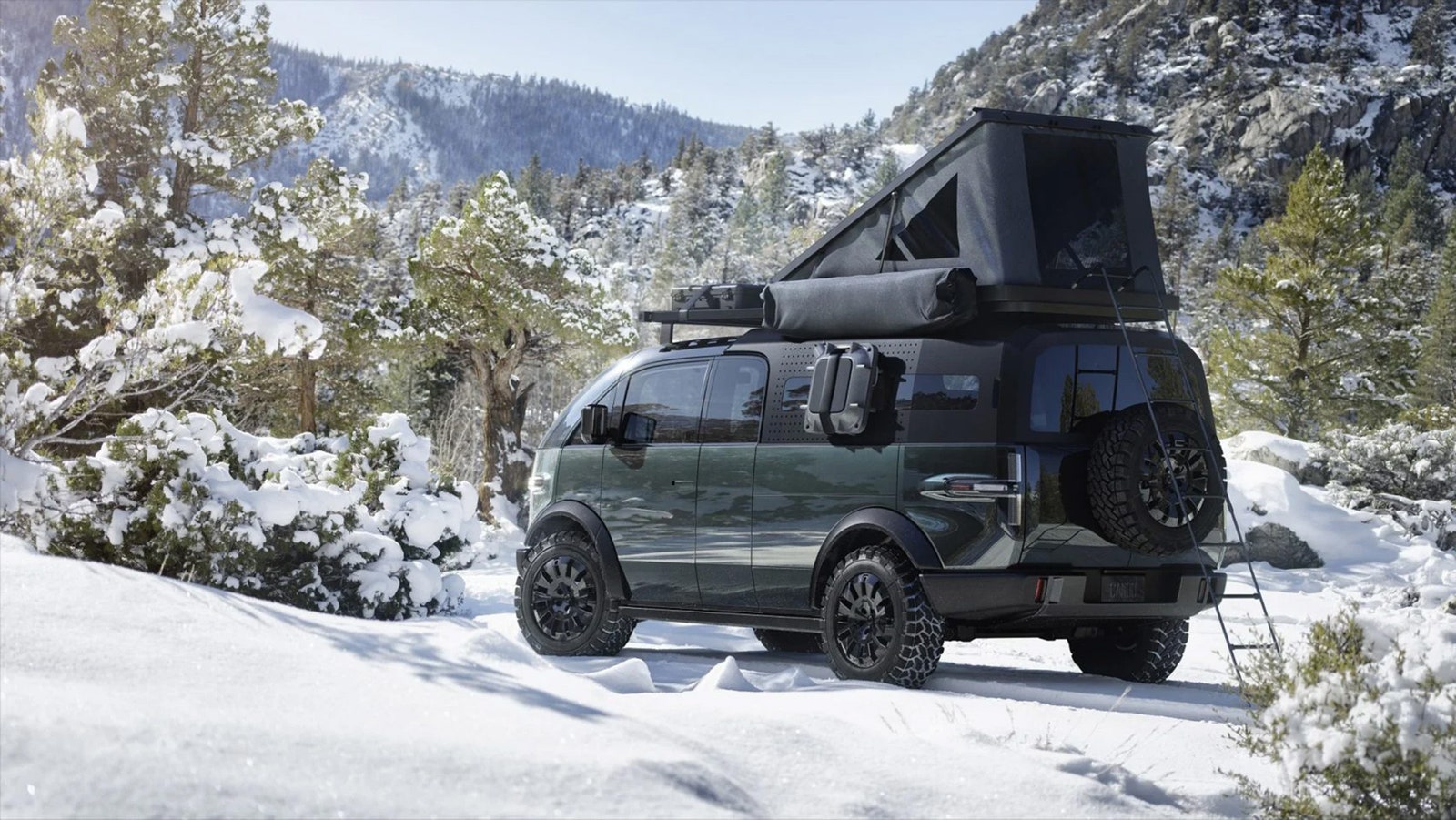 A van with a camper tent on top in the snowy wilderness