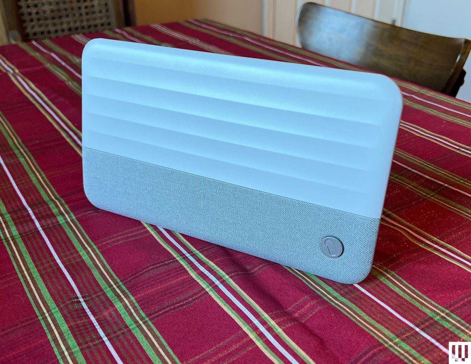 One For All Suburbs Ultimate antenna a white rectangular device sitting on a striped tablecloth