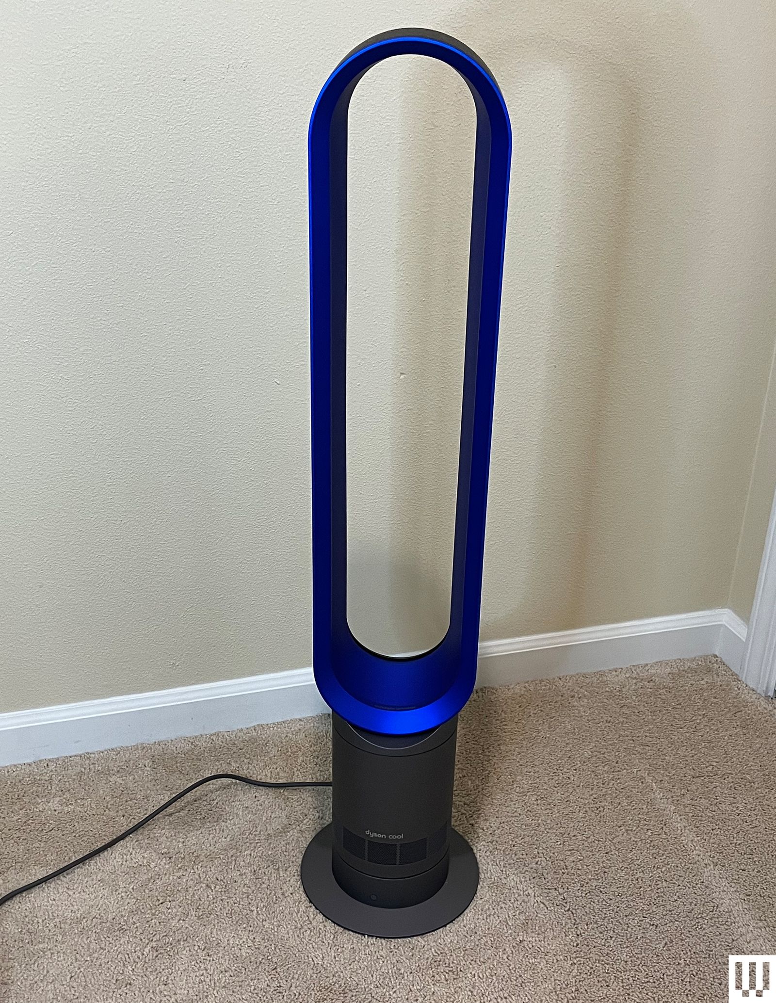 Dyson Cool AM07 Tower Fan a tall slim ovalshaped fan in a carpeted room