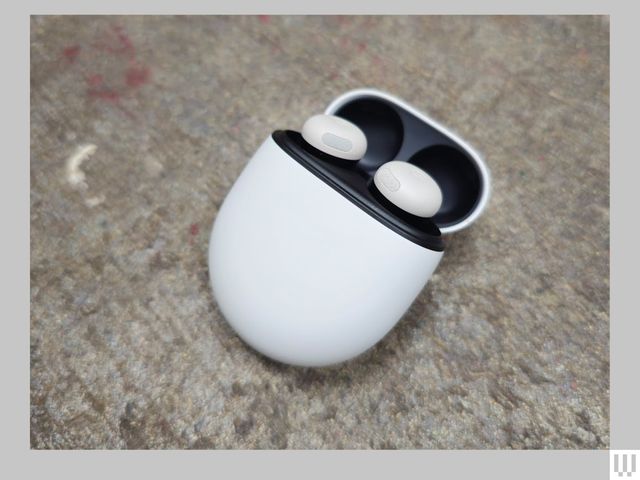 White earbuds in an open oval-shaped case