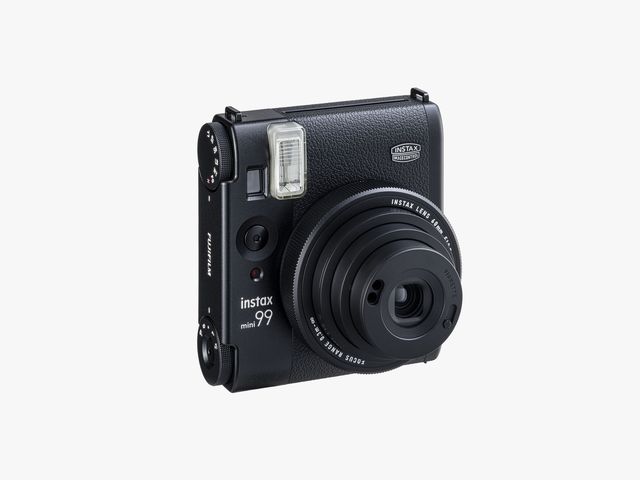 Front view of black instant film camera with the lens extended