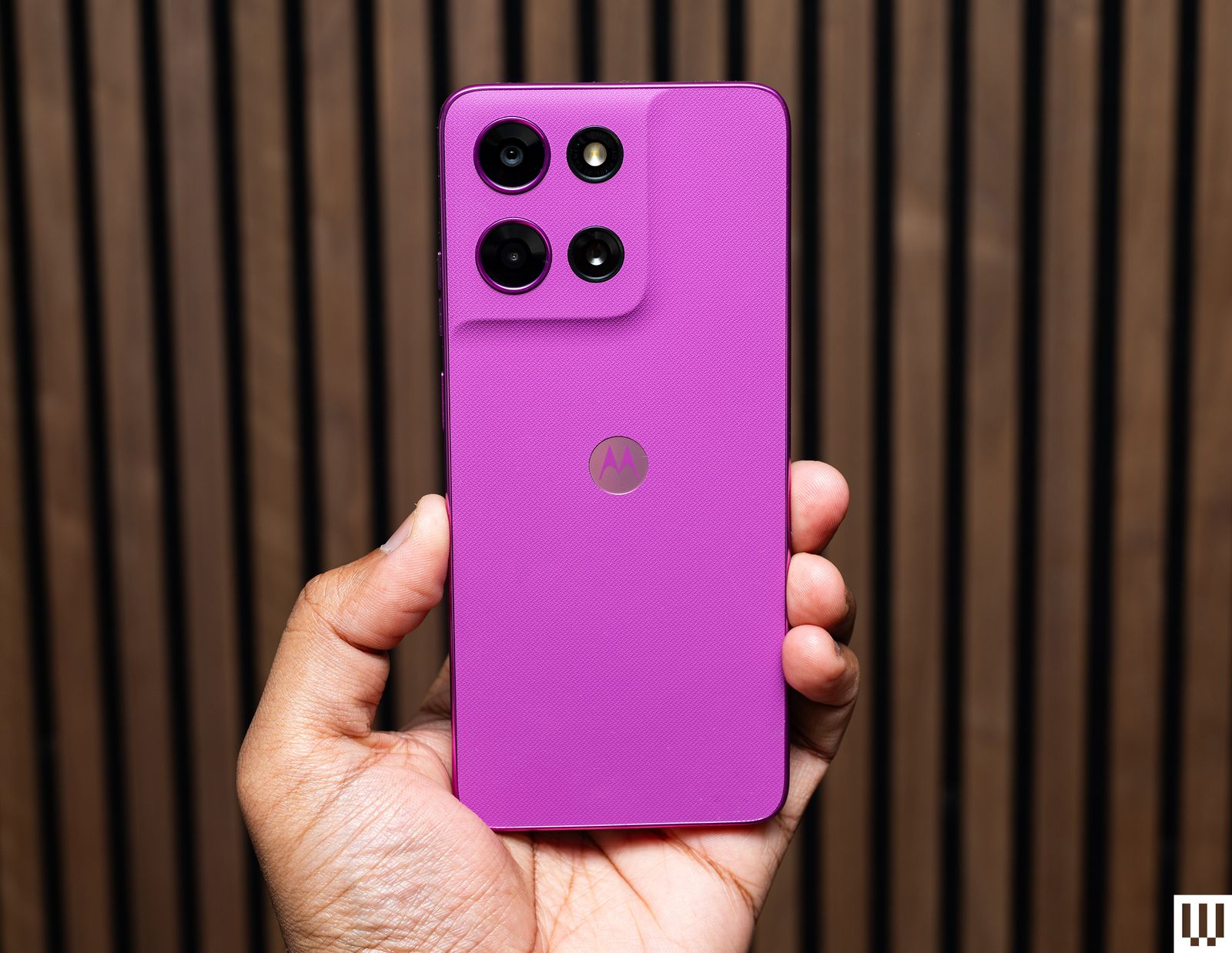 Hand holding up a pink Moto G 5G 2026 phone showing the cameras on the rear