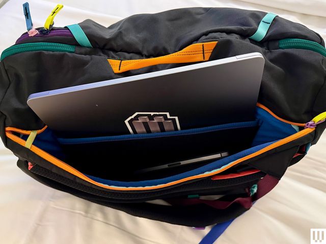 Overhead view of a travel bag with a side pockets holding a laptop and tablet