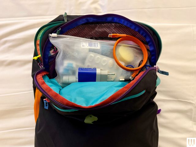 Inside of a travel pouch, showing toiletries and accessories