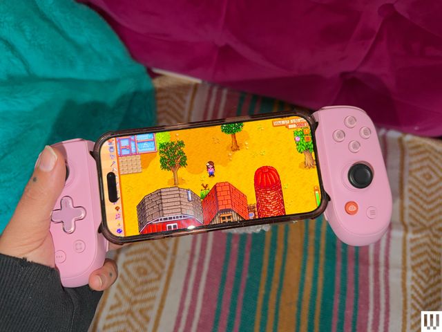 Pink controllers on either side of a mobile phone