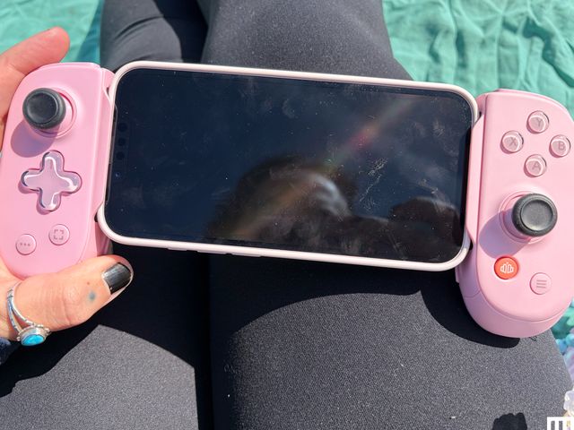 Pink controllers on either side of a mobile phone