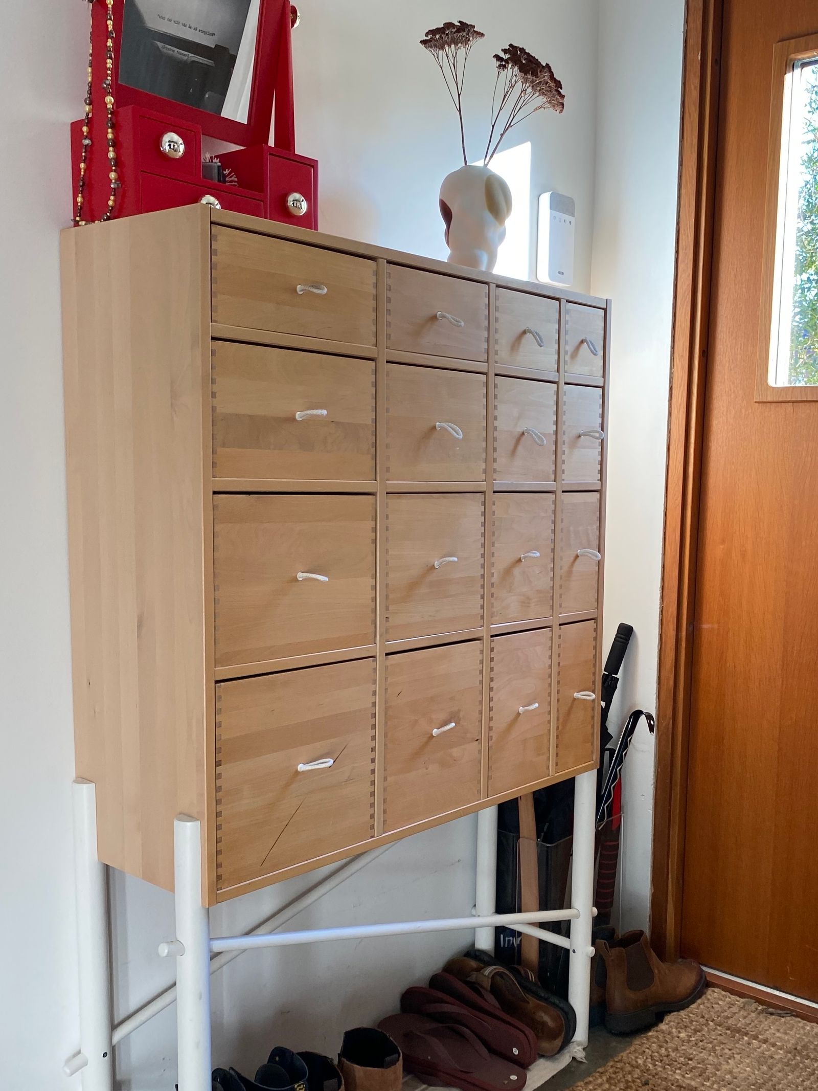 Image may contain Furniture Home Decor Rug Clothing Footwear Shoe and Chest Of Drawers