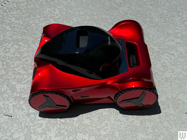 Red pool cleaner with black top and sleek racecar-like edges